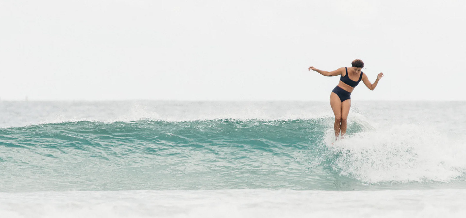 Person surfing on a wave in the ocean