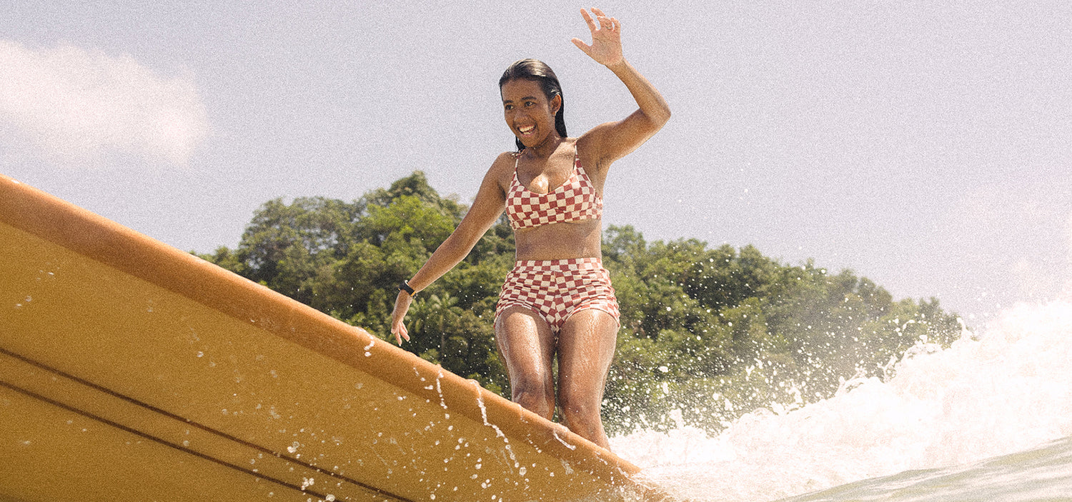 Woman Surfing in check bikini
