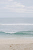 Woman standing in front of ocean wearing Surf_Bikini_Bottom_Lucky_Sea_Foam_Camo