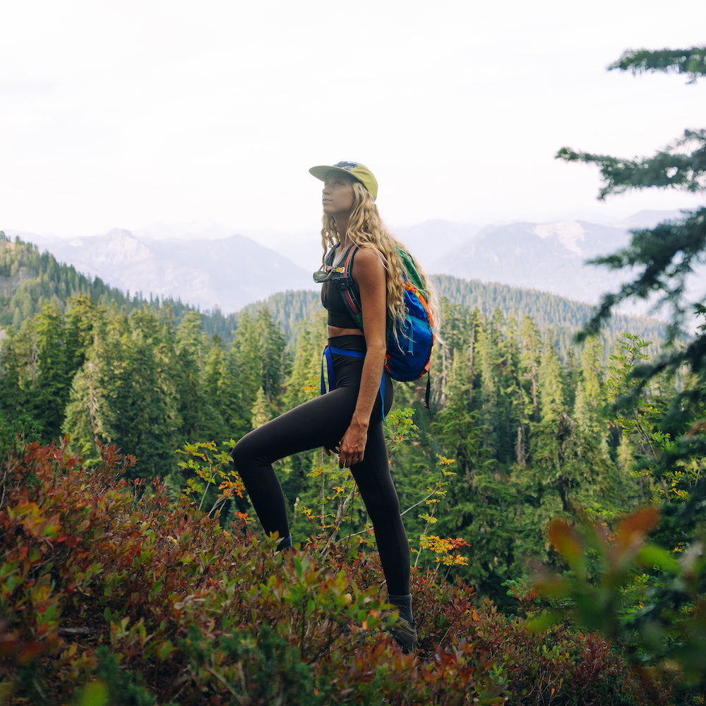 Woman hiking and standing on a hill