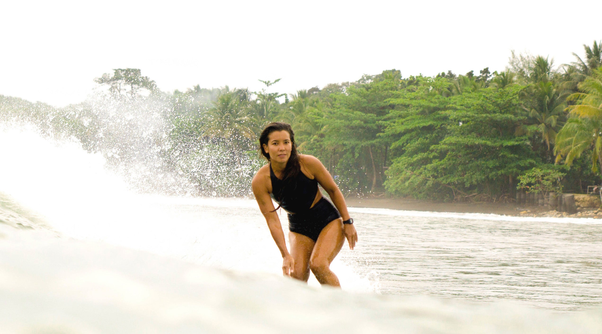 Erika Togashi surfing wearing the Malibu one piece surf swimsuit