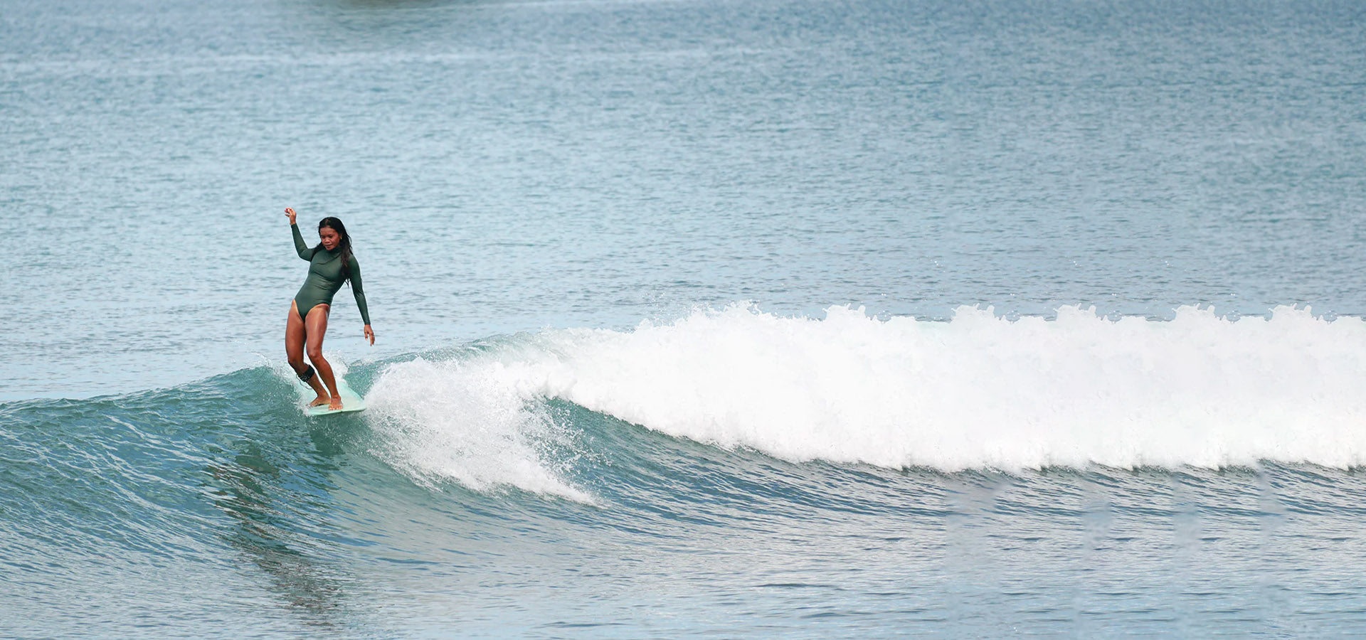 Person surfing on a wave in the ocean