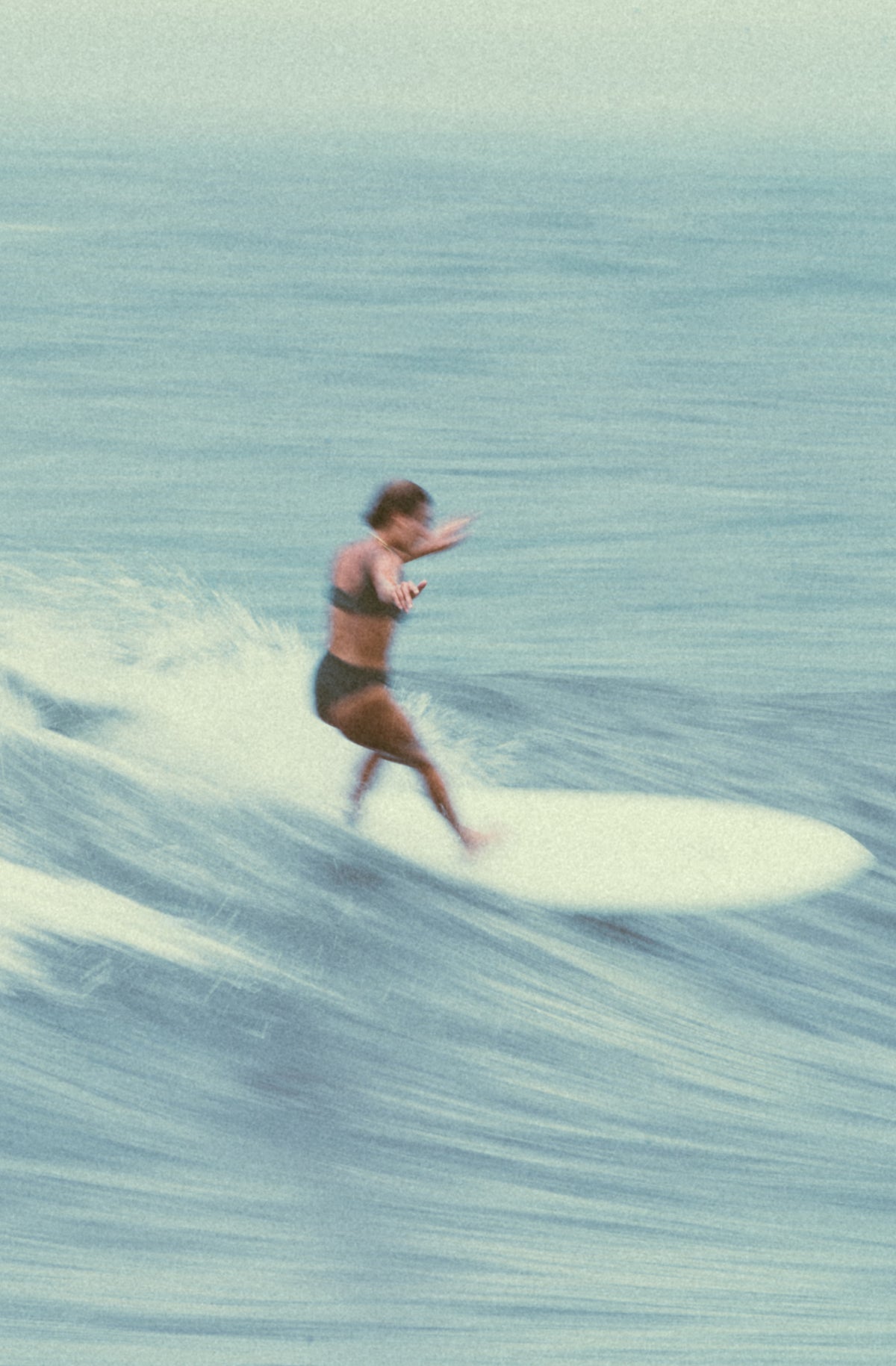 Person surfing on a wave in the ocean