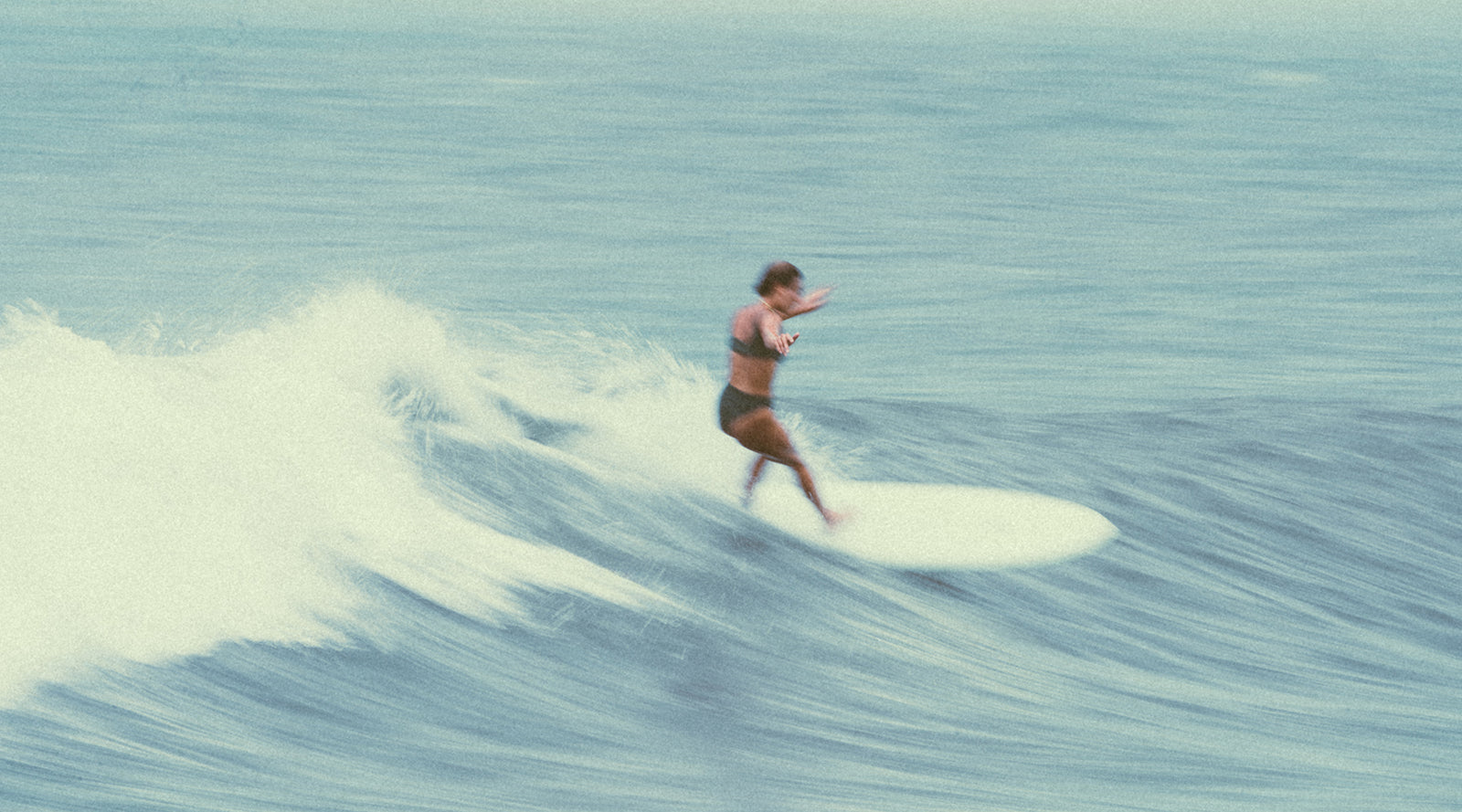 Person surfing on a wave in the ocean