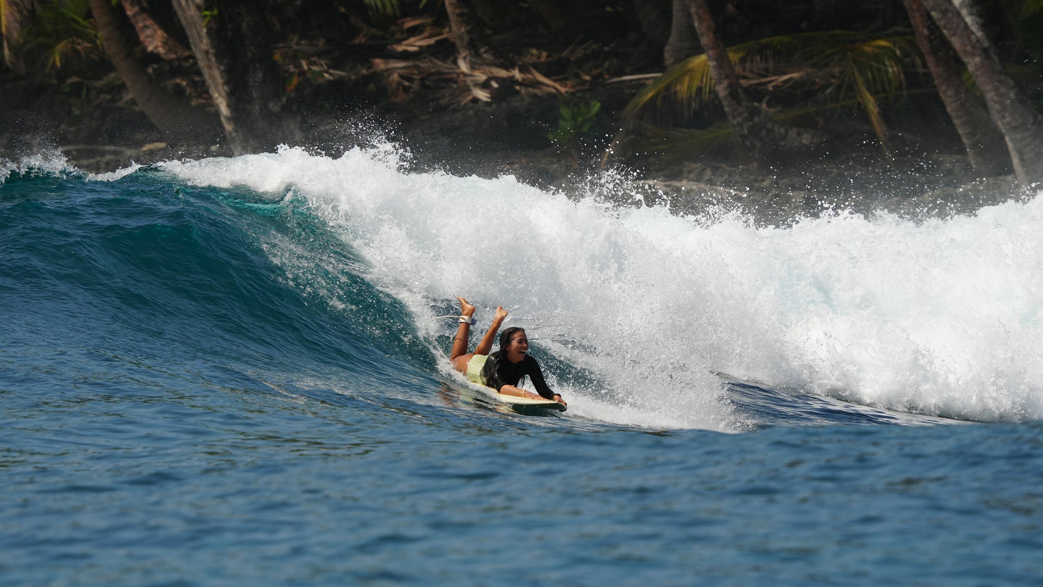 woman on a surfboard smiling