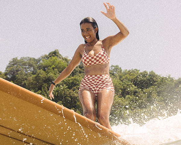 Woman Surfing in check bikini 