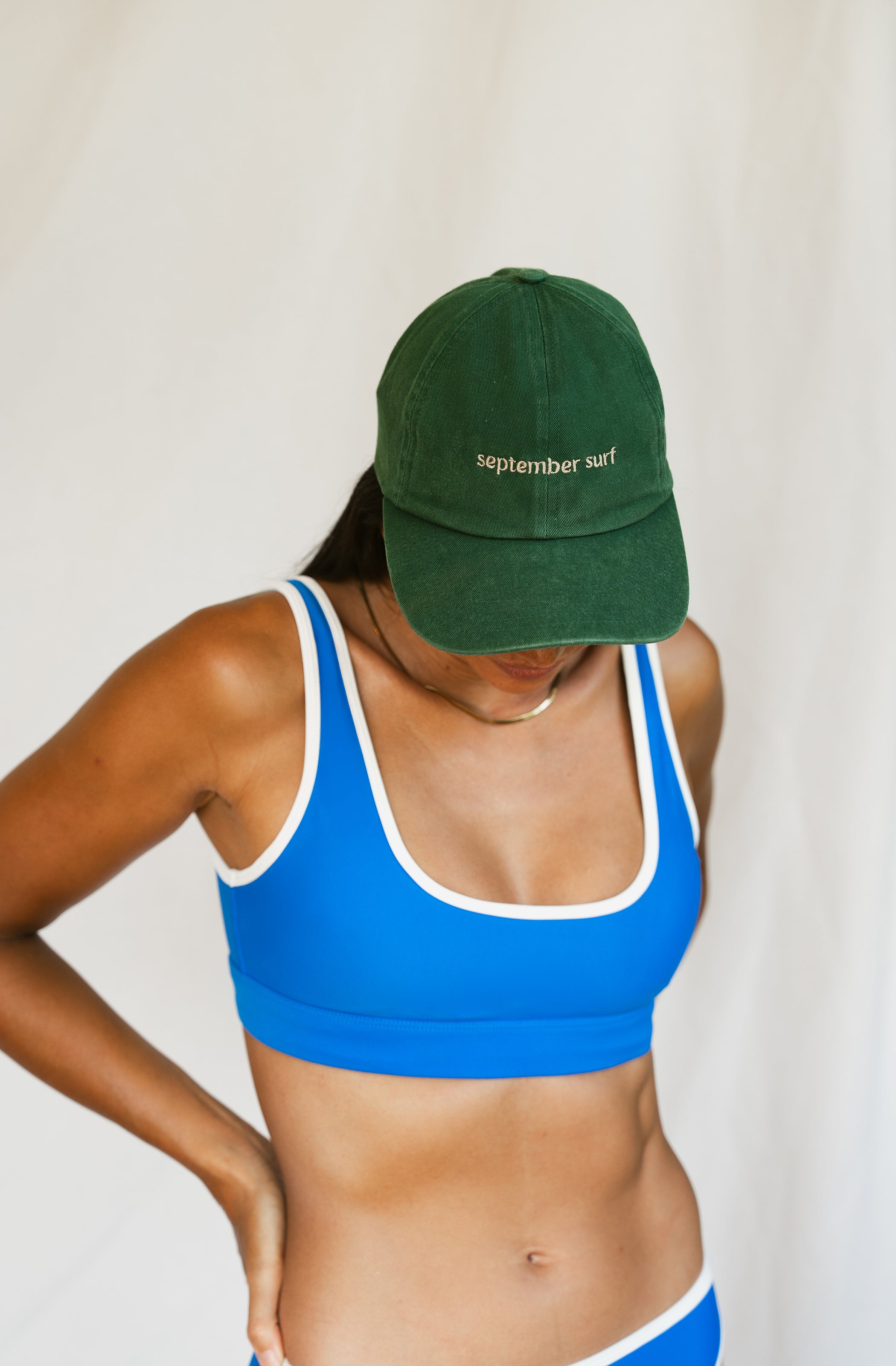 Woman wearing a green baseball cap