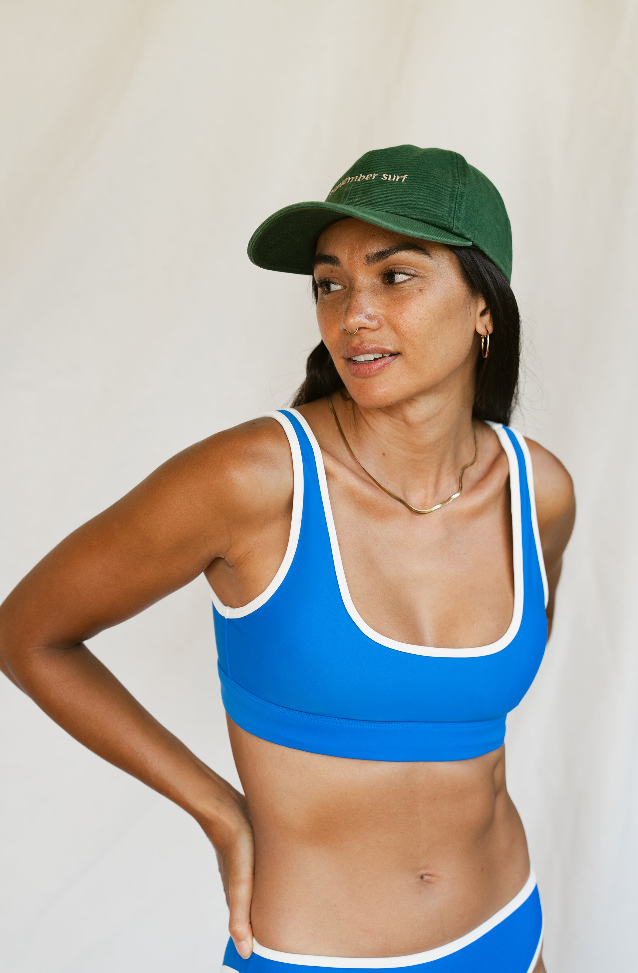 Woman wearing a green baseball cap