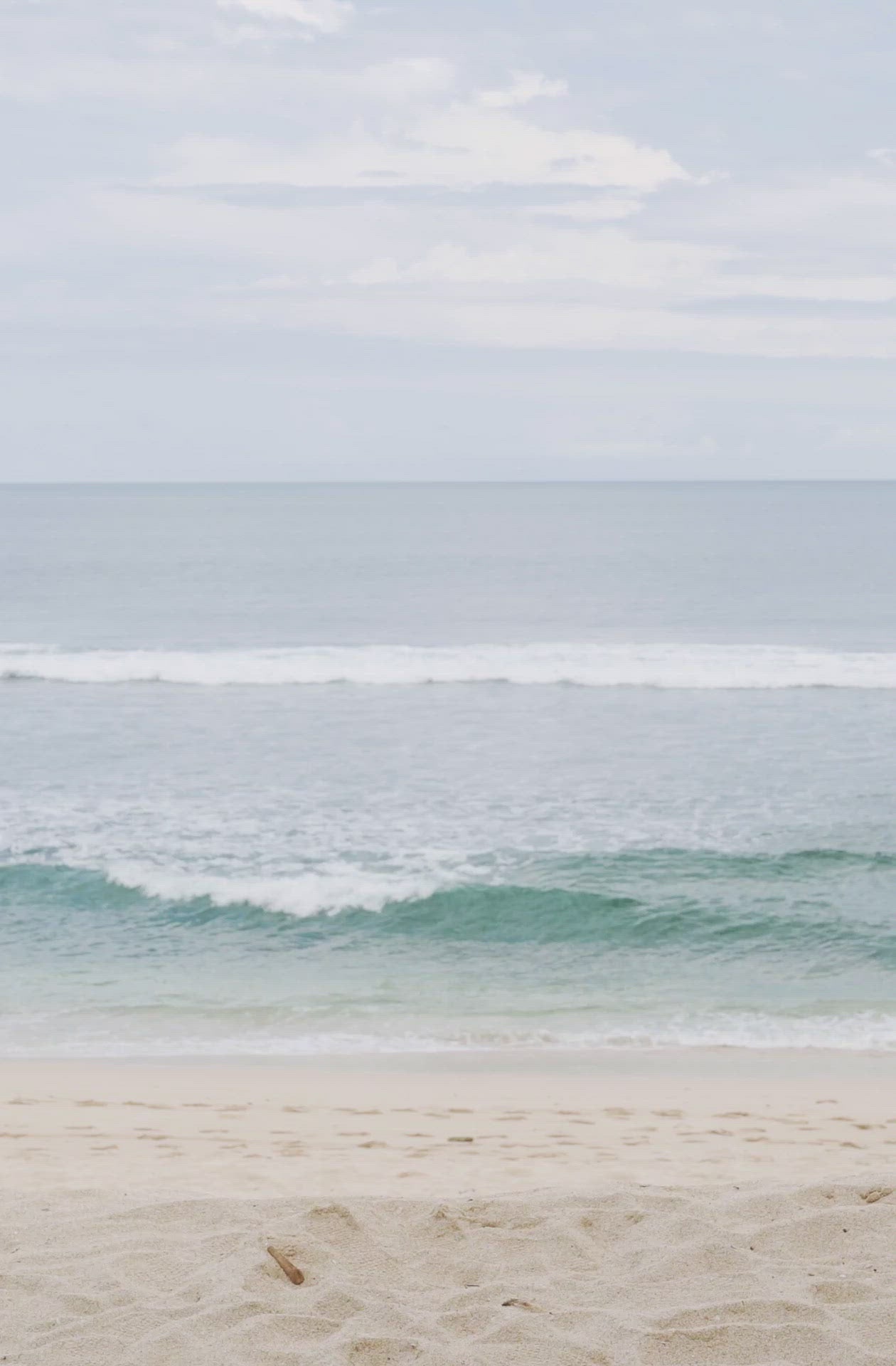 Load video: Woman standing in front of ocean wearing Surf_Bikini_Bottom_Lucky_Sea_Foam_Camo