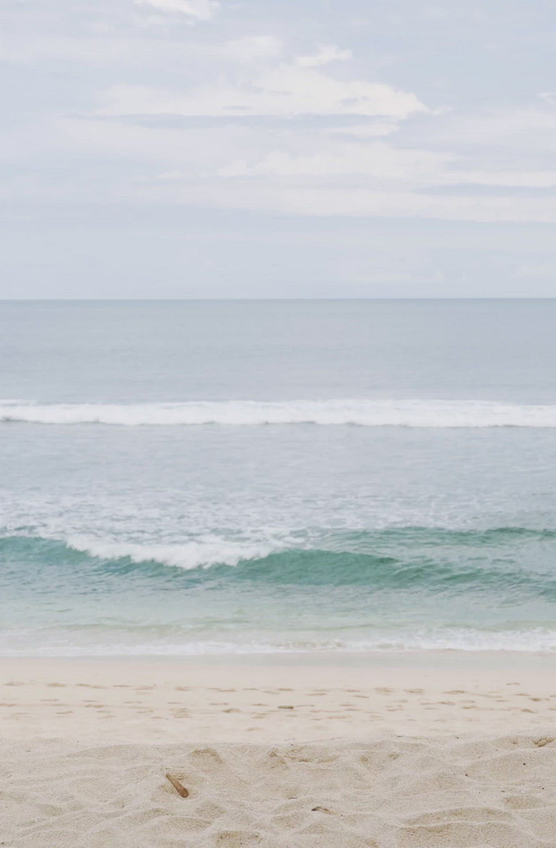 Woman standing in front of ocean wearing Surf_Bikini_Bottom_Lucky_Sea_Foam_Camo