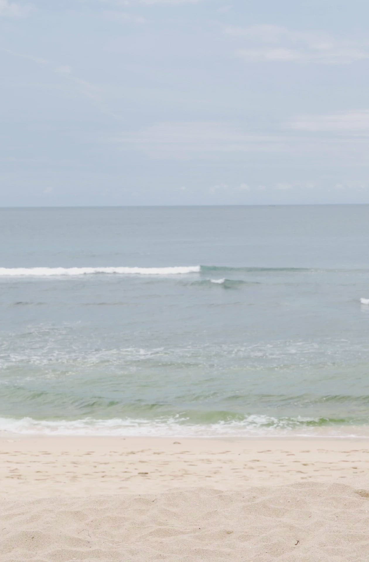 Load video: Woman standing in front of ocean wearing Surf_Bikini_Top_Rita_Guava_Eco_Rib