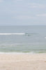 Woman standing in front of ocean wearing Surf_Bikini_Top_Rita_Guava_Eco_Rib