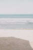 Woman standing in front of ocean wearing Surf_Bikini_Bottom_Lolita_Guava_Eco_Rib
