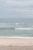 Woman standing in front of ocean wearing Surf_Suit_Baja_Copper_Caramel