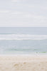 Woman standing in front of ocean wearing    Surf_One_Piece_Marigold_Sangria_Red
