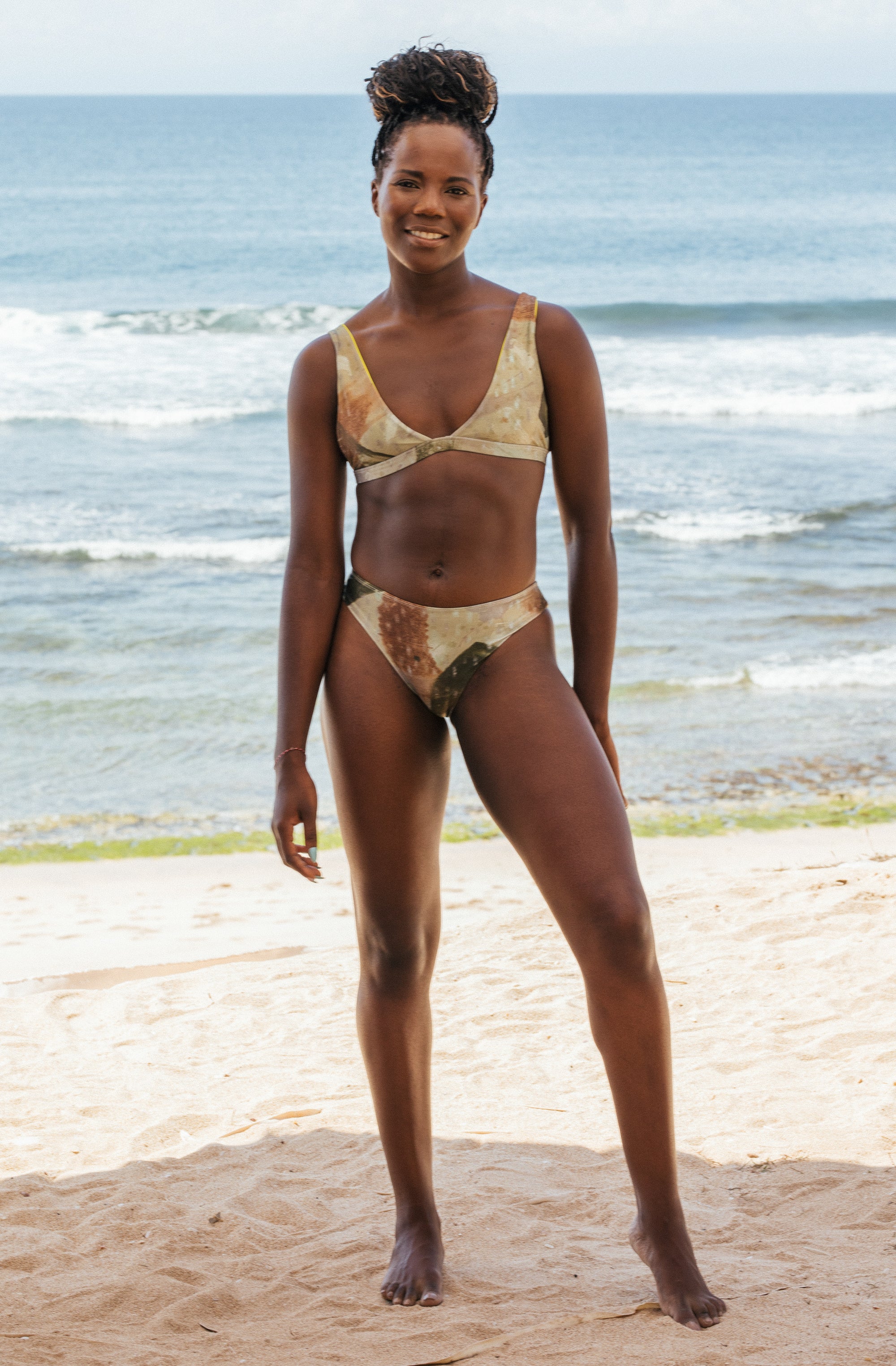 Woman standing in front of ocean wearing Surf_Bikini_Top_Kiyo_Sea_Foam_Camo