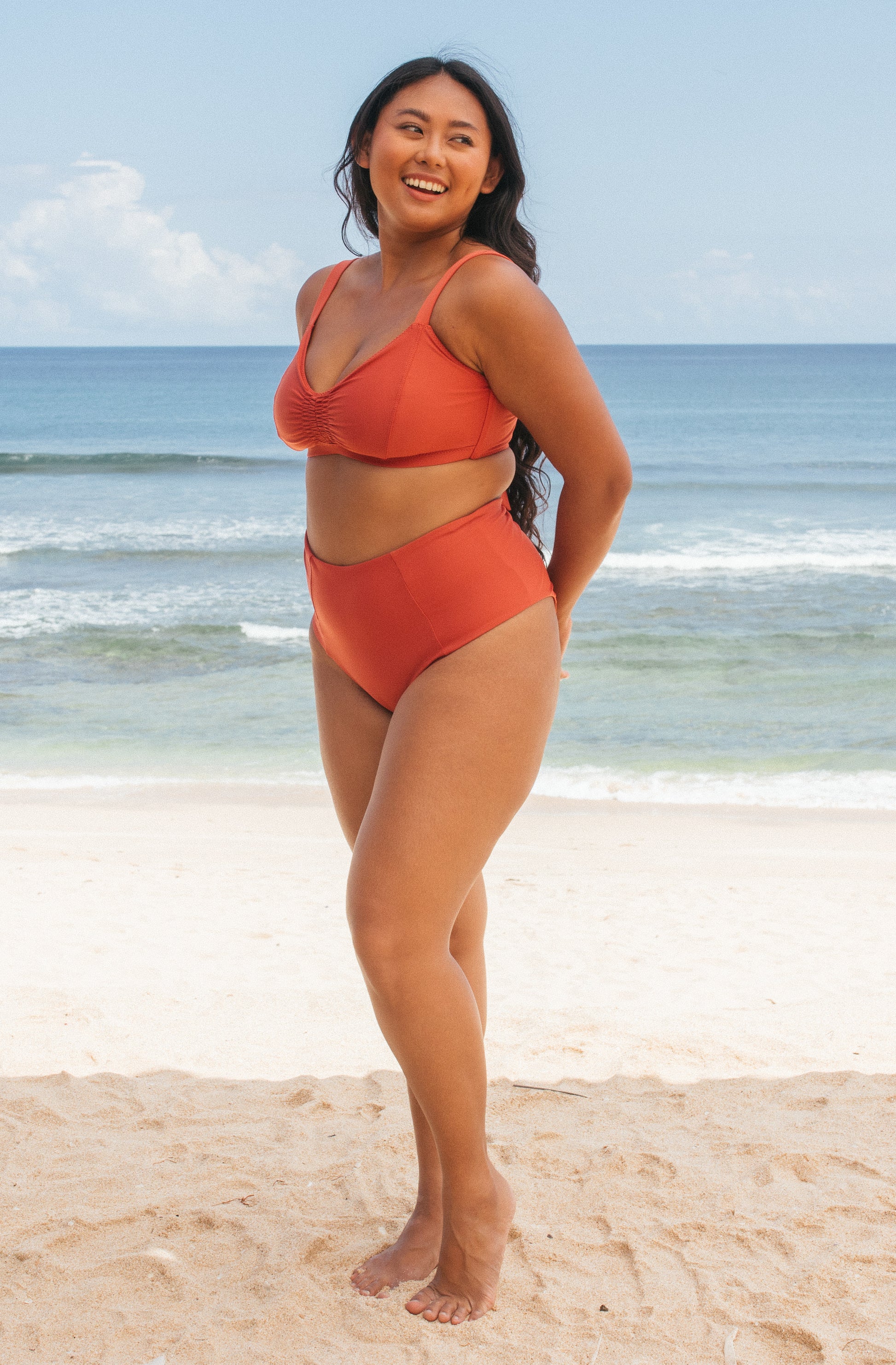 Woman standing in front of ocean wearing Surf_Bikini_Top_Lori_Burnt_Sienna 