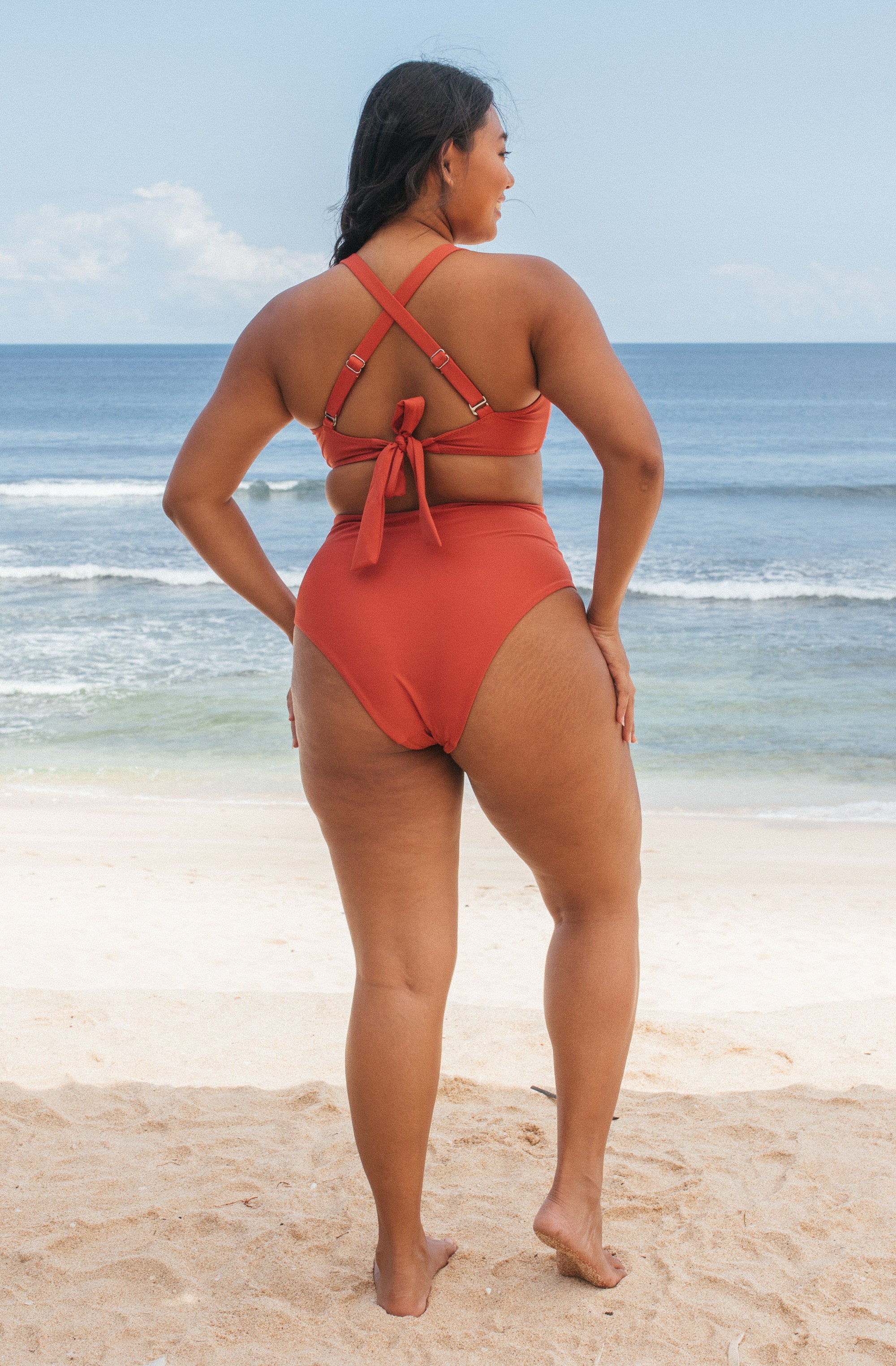 Woman standing in front of ocean wearing Surf_Bikini_Top_Lori_Burnt_Sienna 