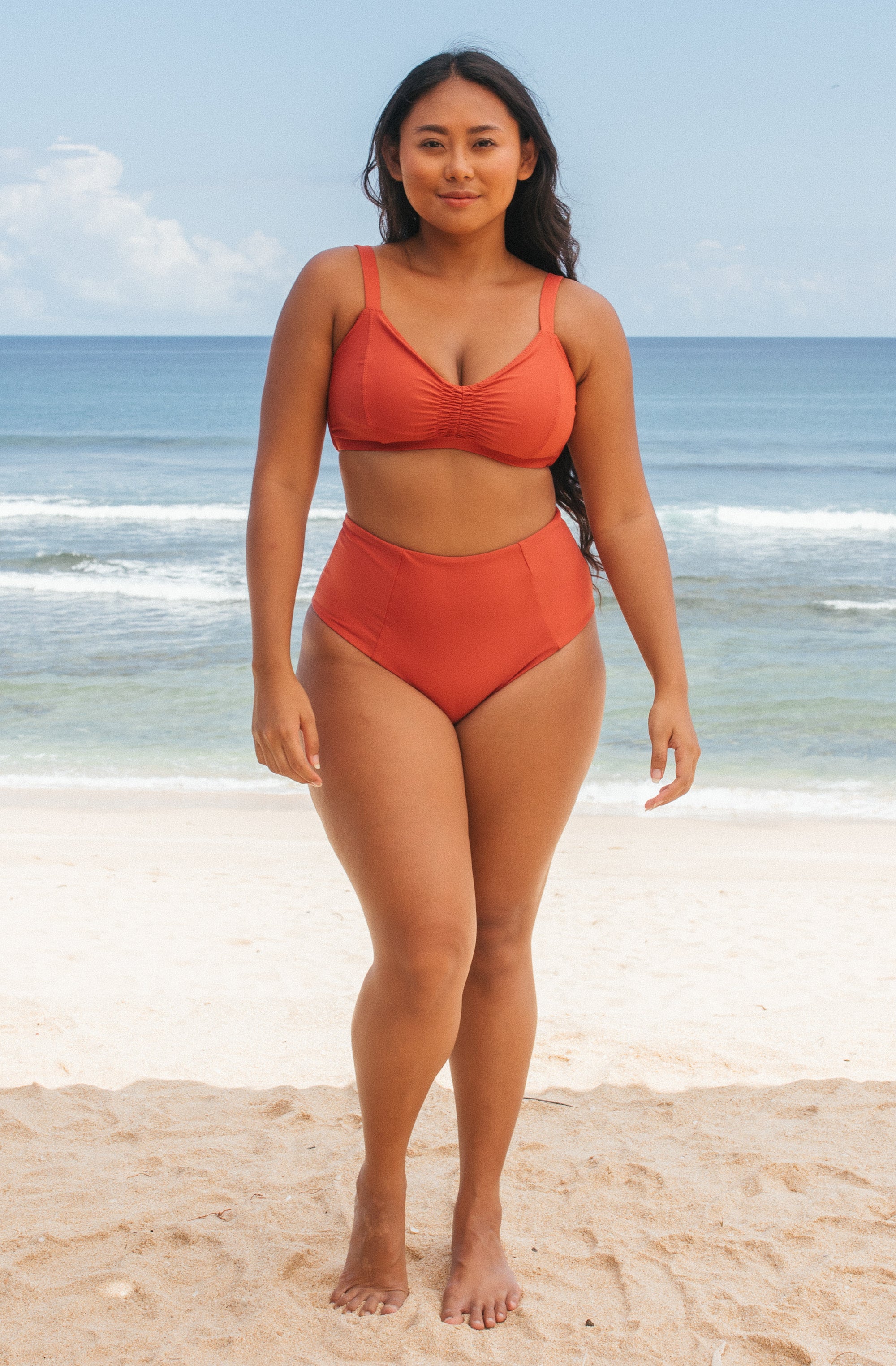 Woman standing in front of ocean wearing Surf_Bikini_Top_Lori_Burnt_Sienna 