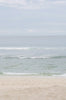 Woman standing in front of ocean wearing Surf_Bikini_Bottom_Kennedy_Caper_Eco_Rib