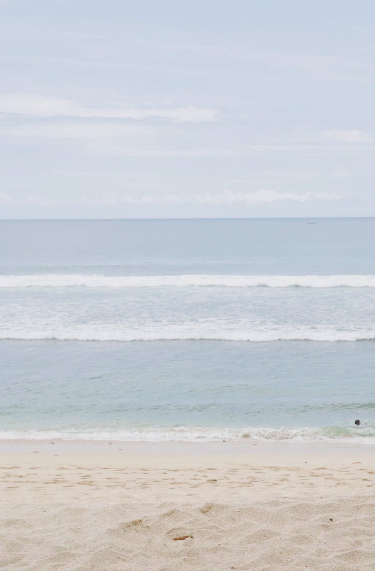 Load video: Woman standing in front of ocean wearing Surf_One_Piece_Marigold_Olive