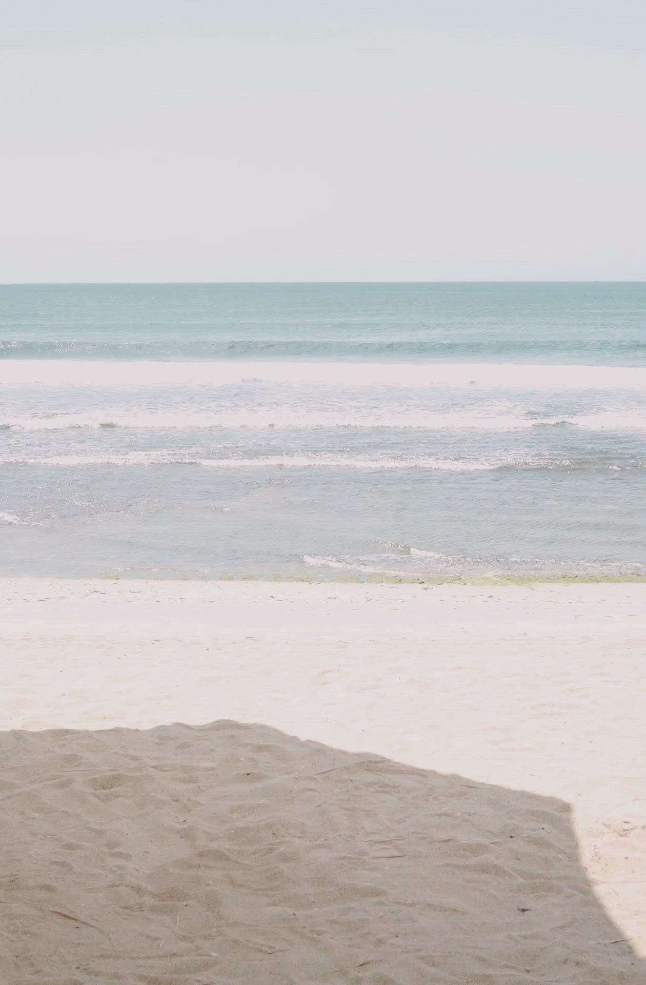 Load video: Woman standing in front of ocean wearing Surf_Bikini_Top_Rita_Guava_Eco_Rib