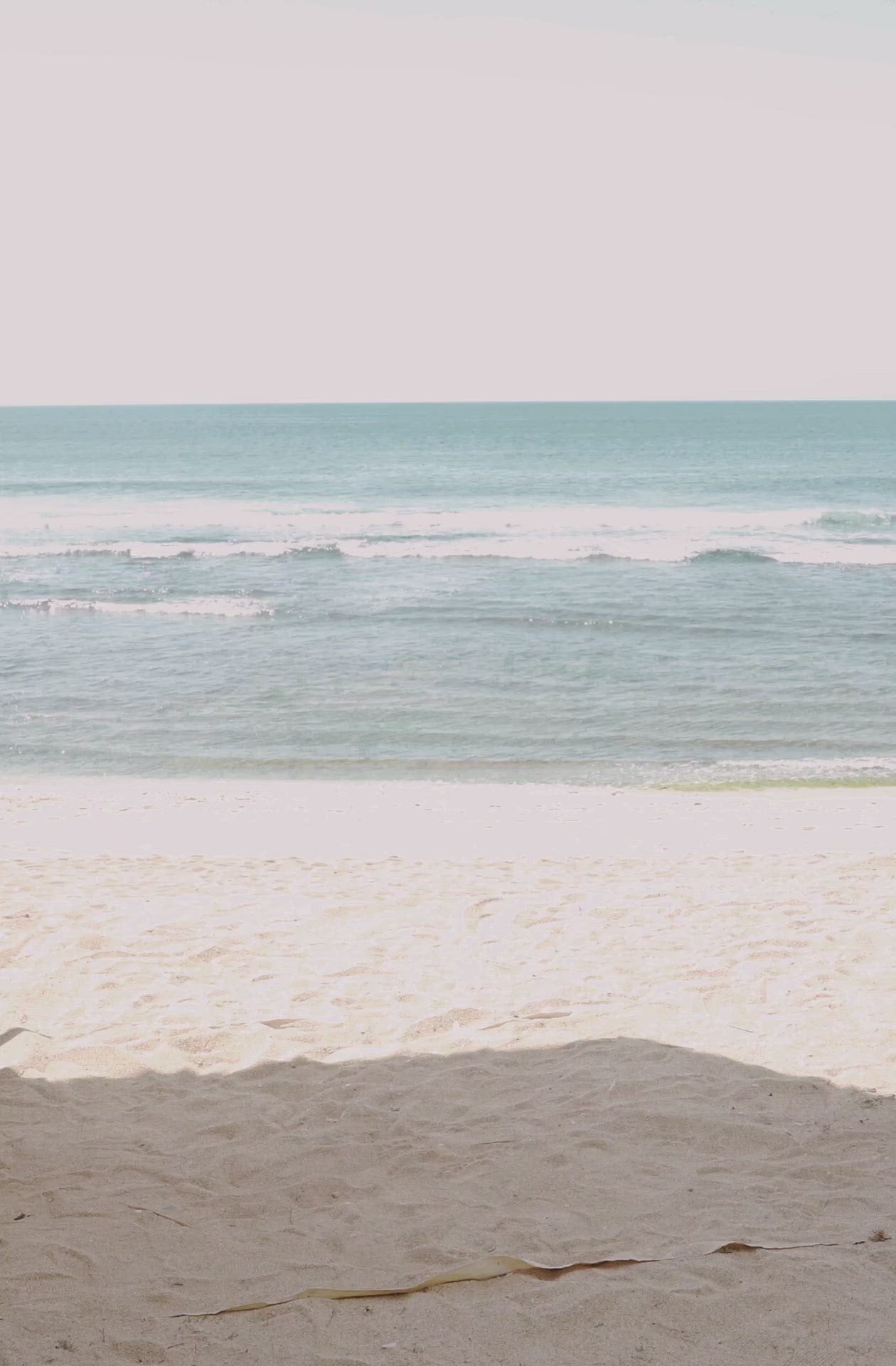 Load video: Woman standing in front of ocean wearing Surf_One_Piece_Malibu_Burnt_Ivory
